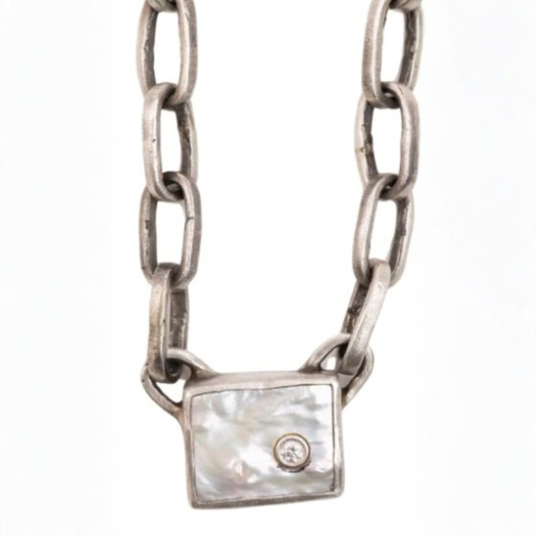 Silver-toned chain necklace featuring elongated oval links and a square iridescent pendant with a small round embellishment at its center.