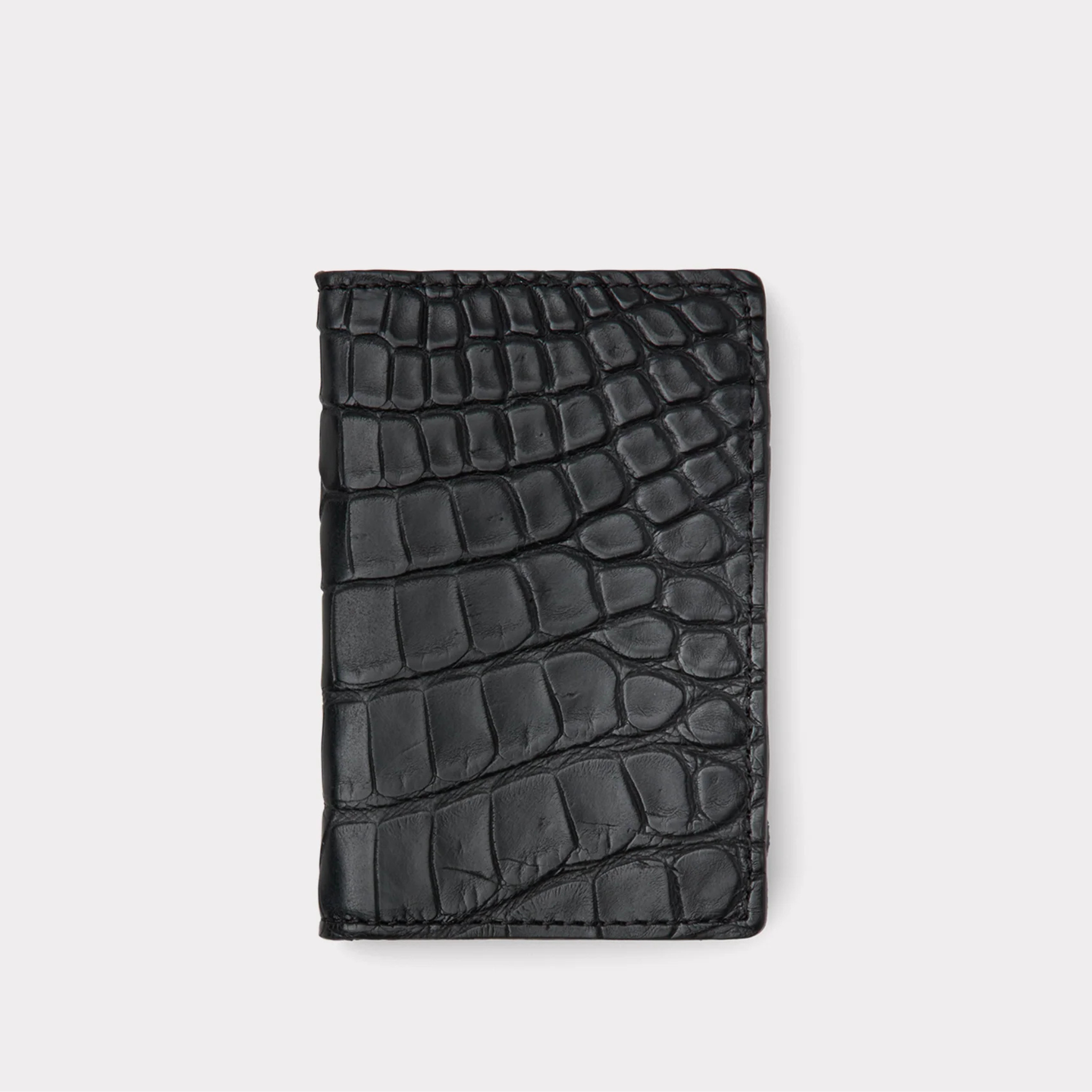 Black crocodile patterned wallet on a light gray background