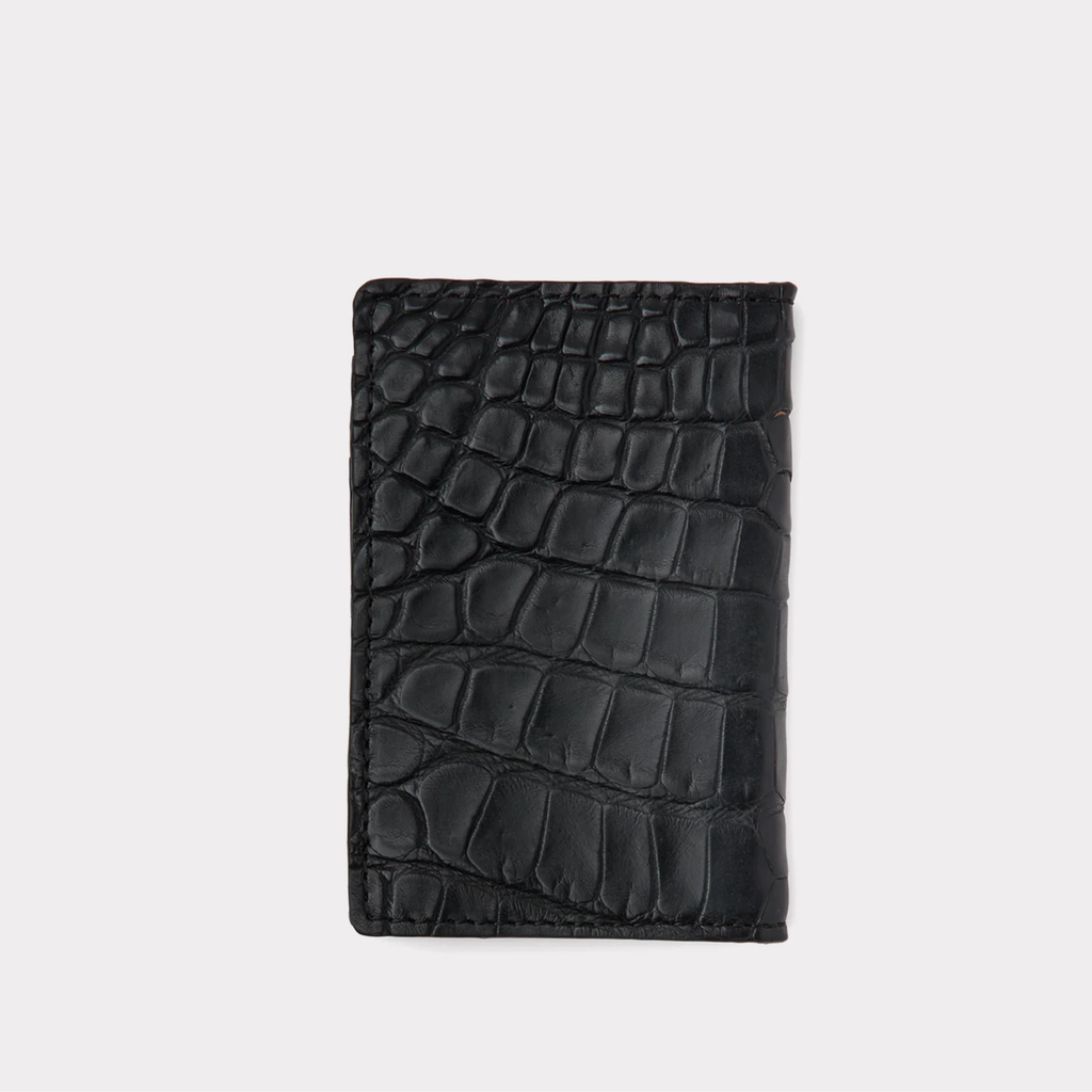 Black crocodile patterned wallet on a light gray background
