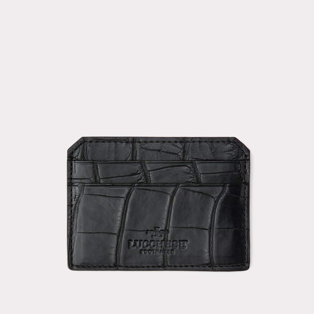 Black alligator cardholder with brand logo on a light gray background