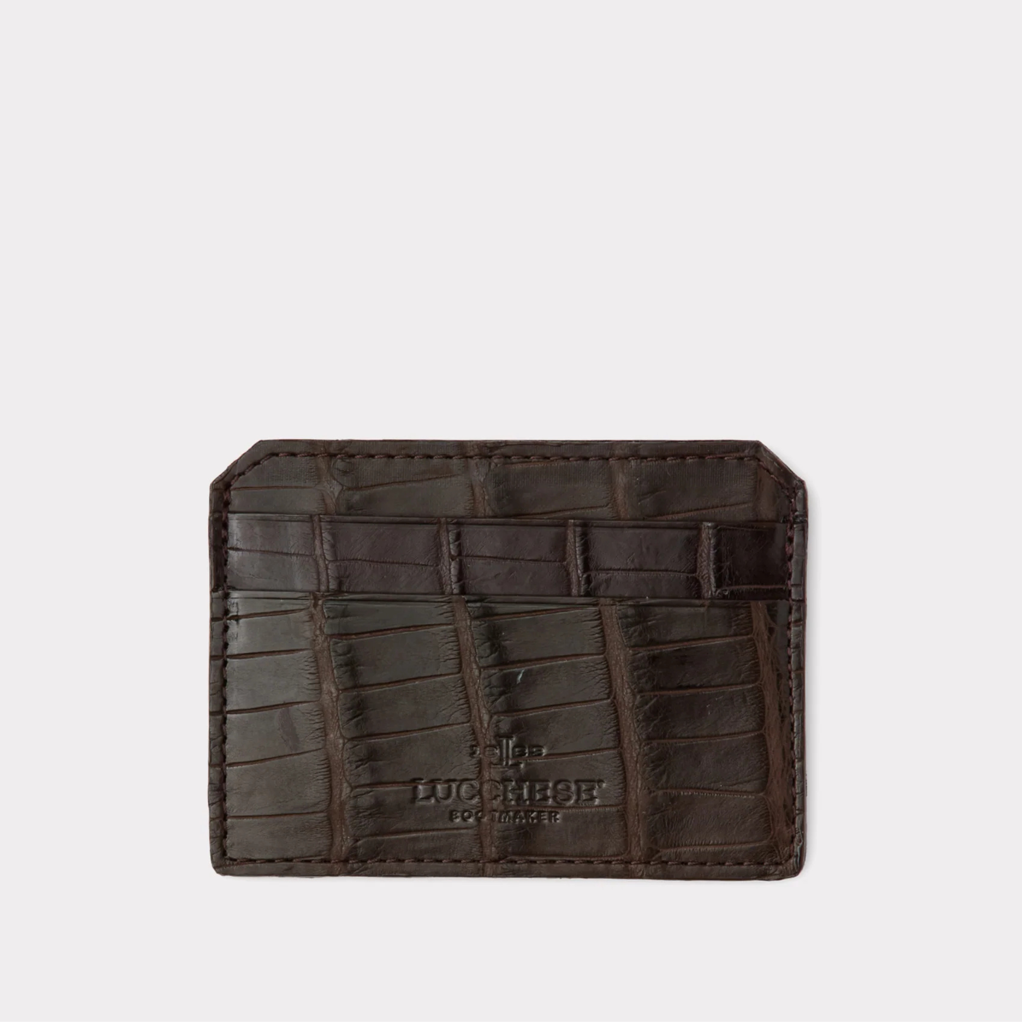 Brown leather wallet with crocodile texture on a light gray background