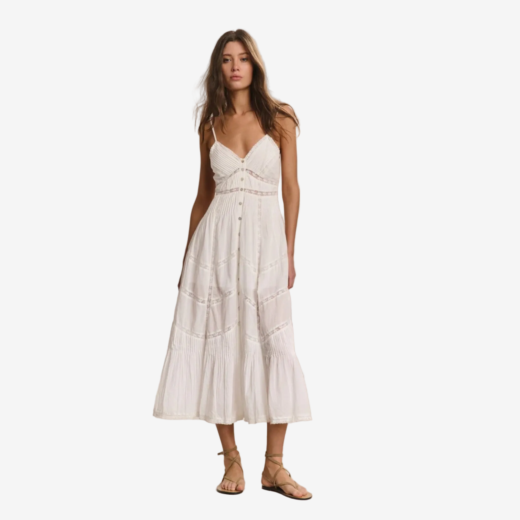 Woman wearing a white dress against a plain background