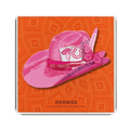 Pink hat with decorative elements on an orange Hermes packaging
