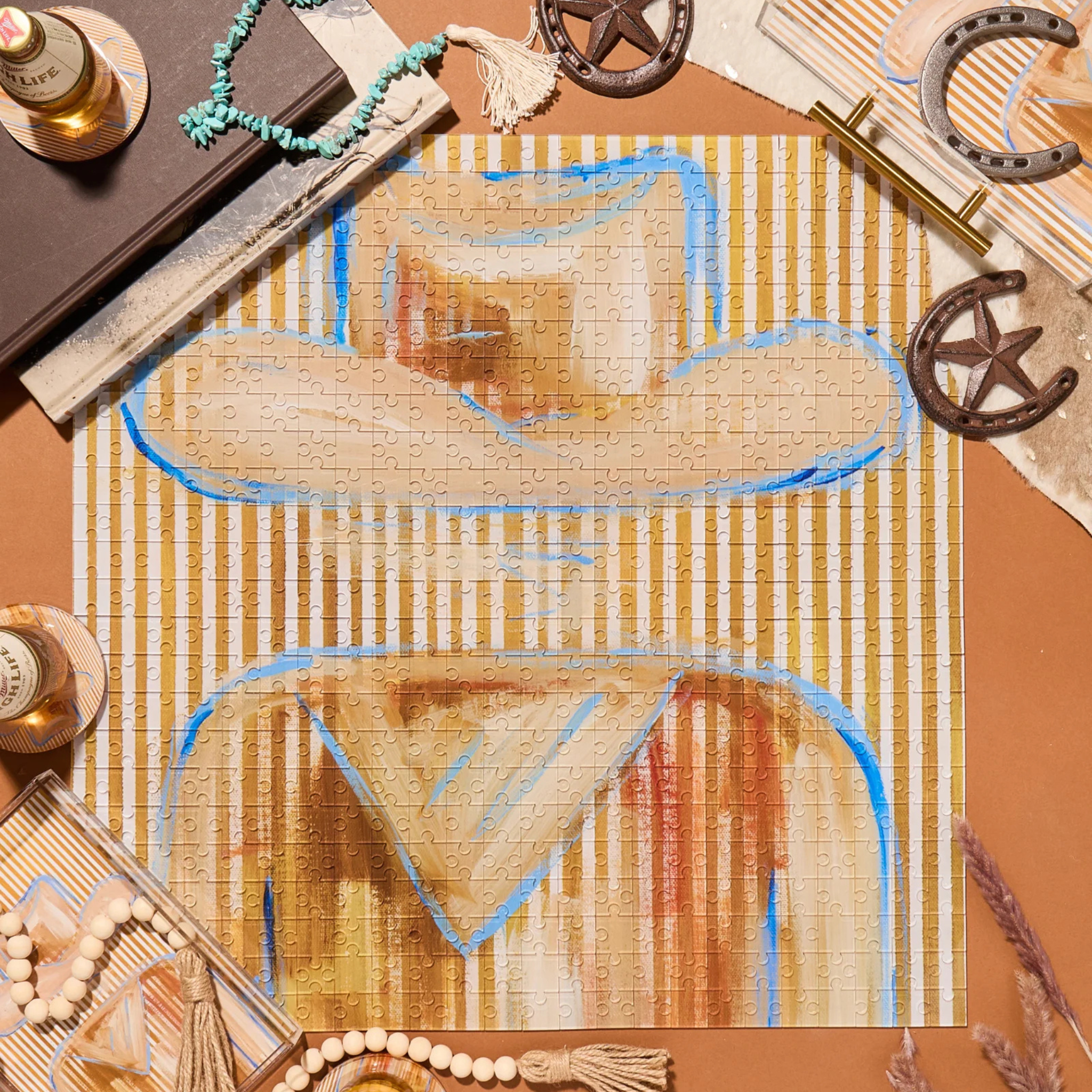 Cowboy hat puzzle on a decorative surface with books and decorative items.