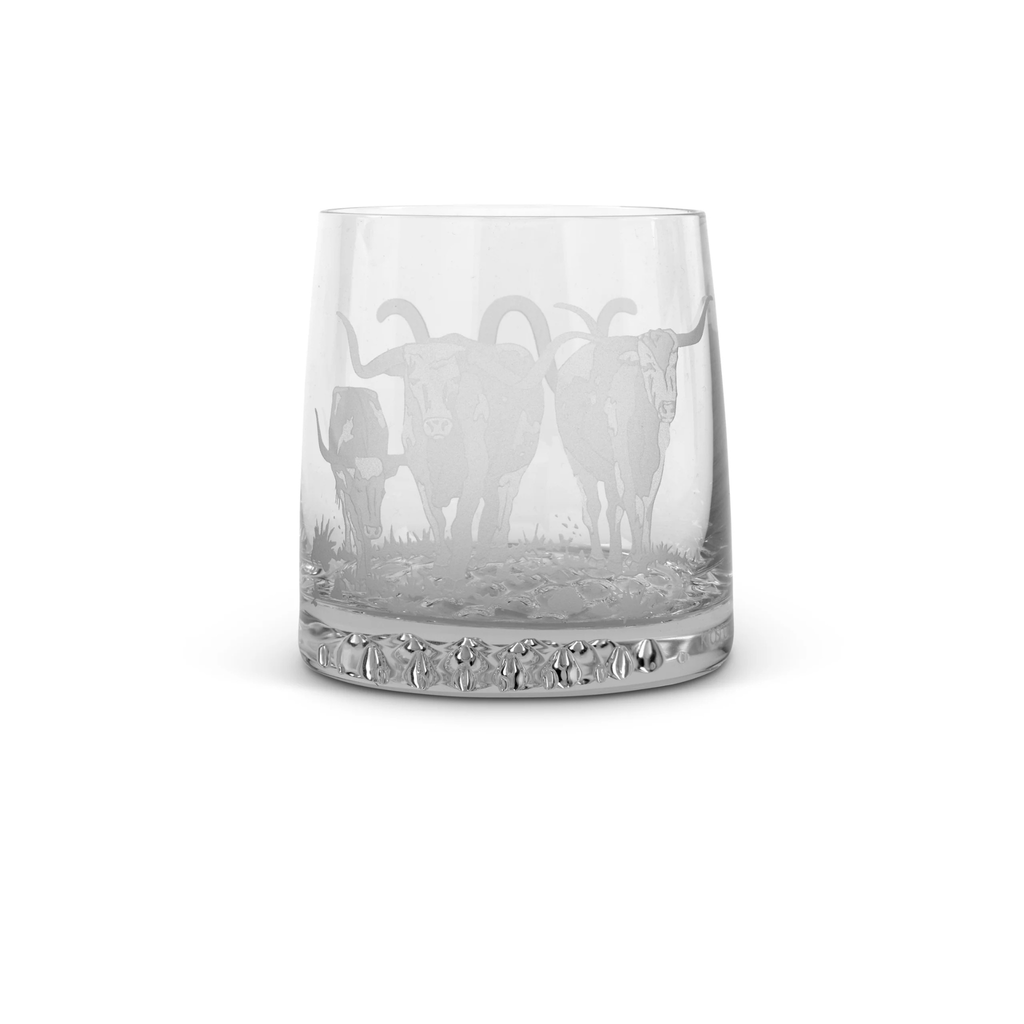 Clear whisky glass  with engraved animal design on a white background