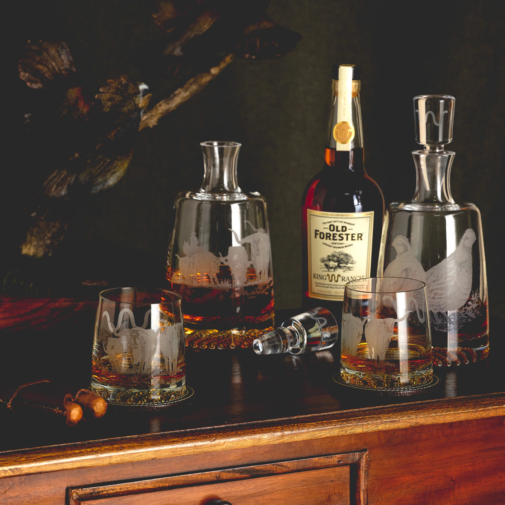 Old Forester whiskey bottle with glasses on a wooden surface