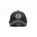 Front view of a Black cap with a 1932 Cattleman's Club logo on a white background
