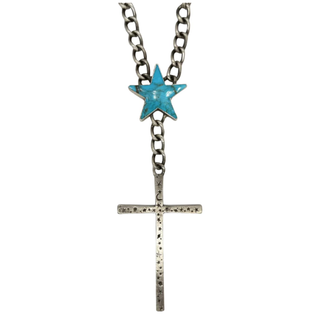 A silver chain necklace featuring a large turquoise star accent and a long silver cross pendant engraved with small stars and crescent moon shapes.