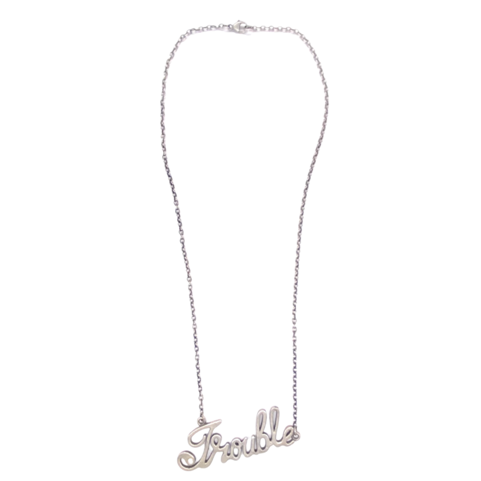 A silver chain necklace featuring a cursive word pendant that reads “Trouble.”